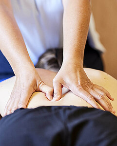 Ein Medical Park Therapeut massiert eine Patientin während einer medizinischen Massagetherapie.